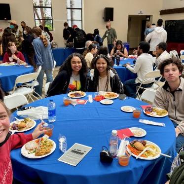 group of people sitting around the table and dinning